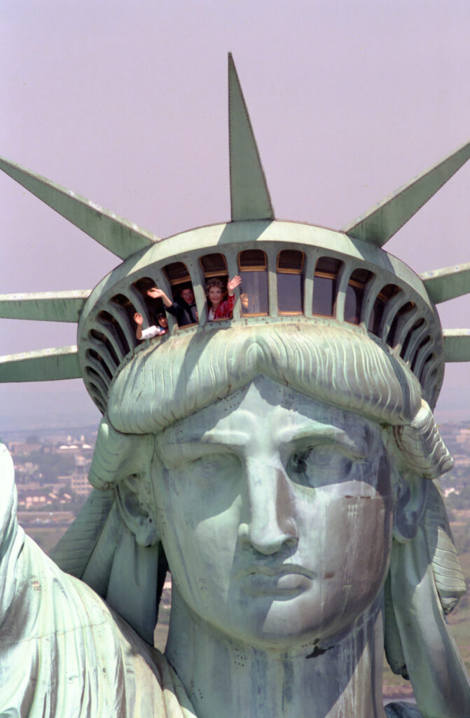 Photo: Nancy Reagan waves while visiting the Statue of Liberty